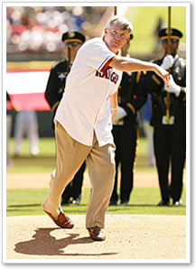 Mack Brown throws out the first pitch before the Texas Rangers season opener