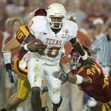 Vince Young runs over a USC defender