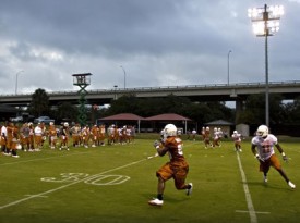 QB Colt McCoy passes to RB Fozzy Whittaker on the first day of practice. (Statesman.com)