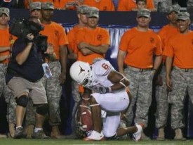 Quan Cosby kneeling after scoring a touchdown